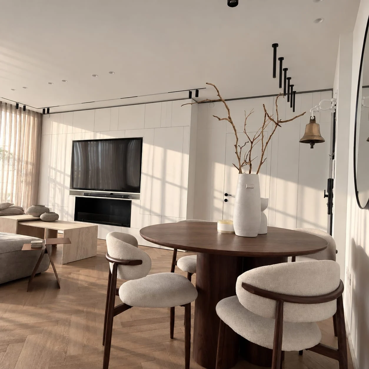 View from the round dining table towards the sofa and television wall