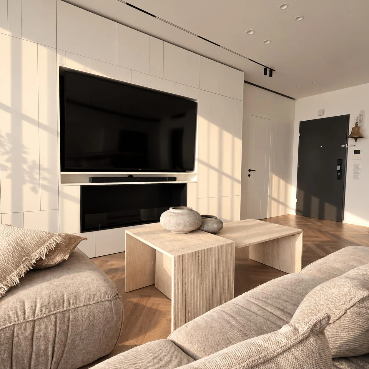 View over the sofa back towards the tables and television wall