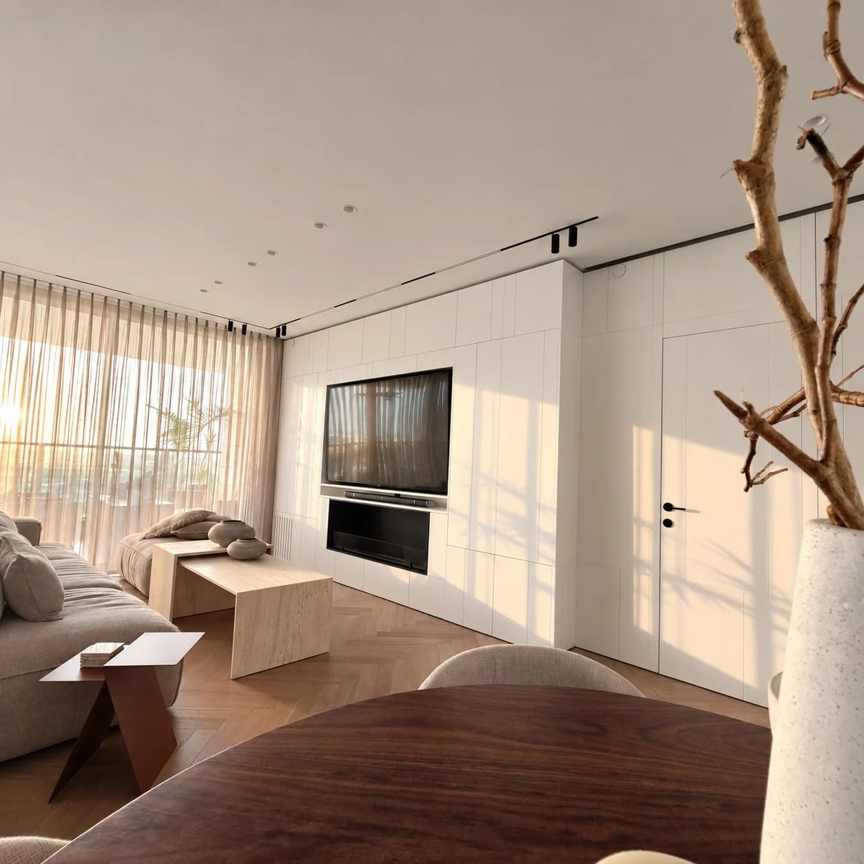 View from the dining area towards the living room and television wall