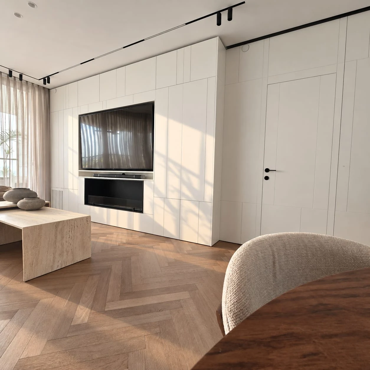 Dining chair in the foreground, with the sofa and television in the background