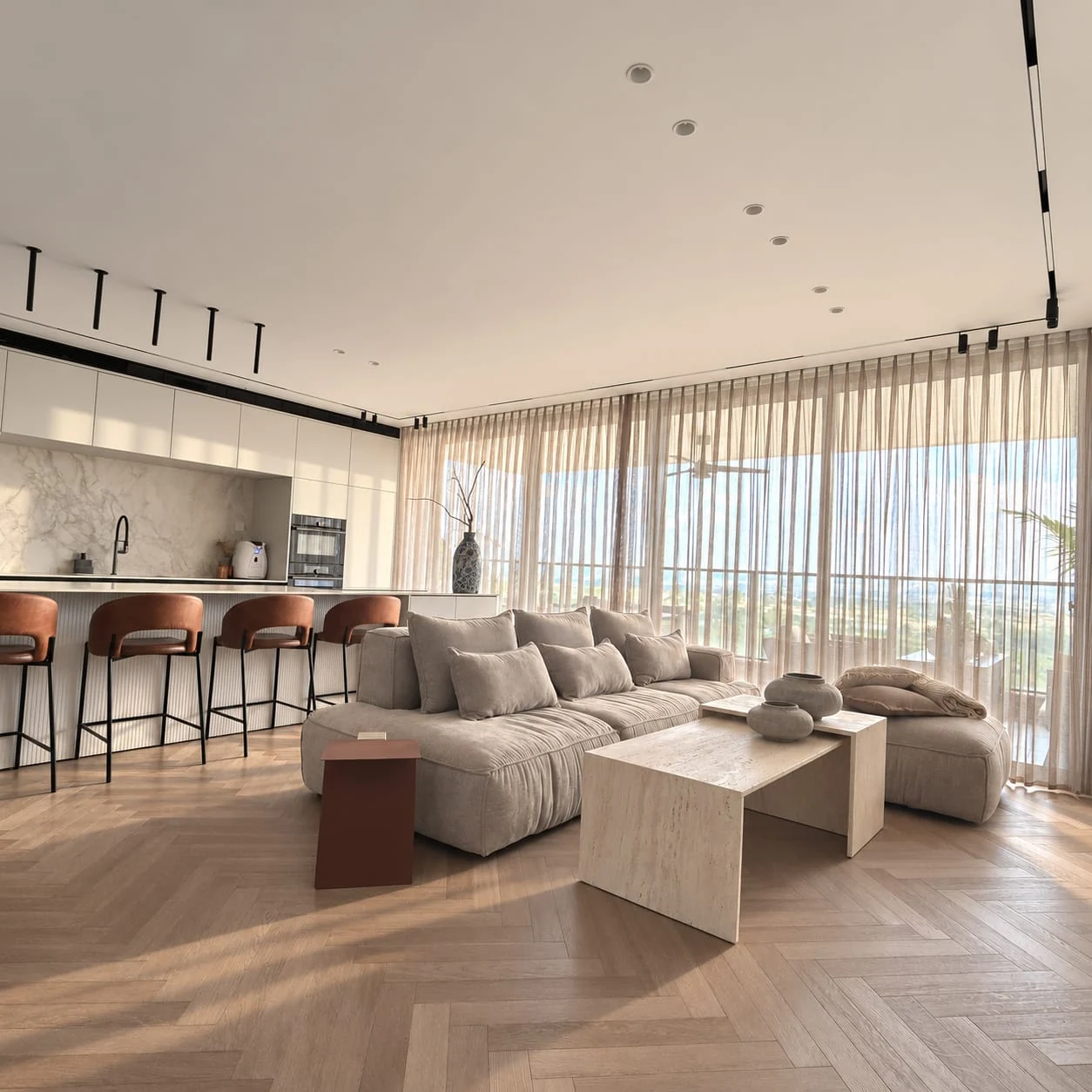 Shared view of kitchen and living room, with a long island and sofa beside the windows