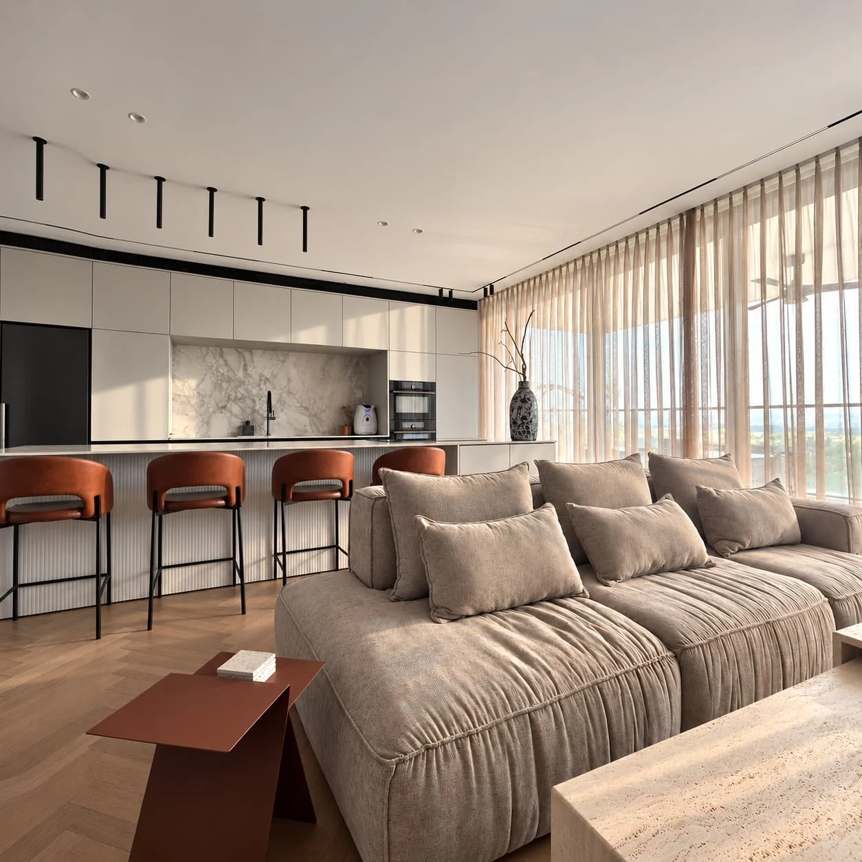 View over the sofa back towards the kitchen island and cognac-coloured stools