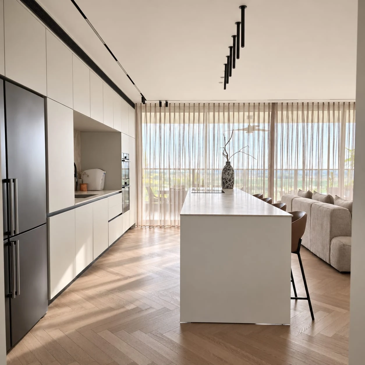 View from the end of the kitchen island towards the worktop and windows