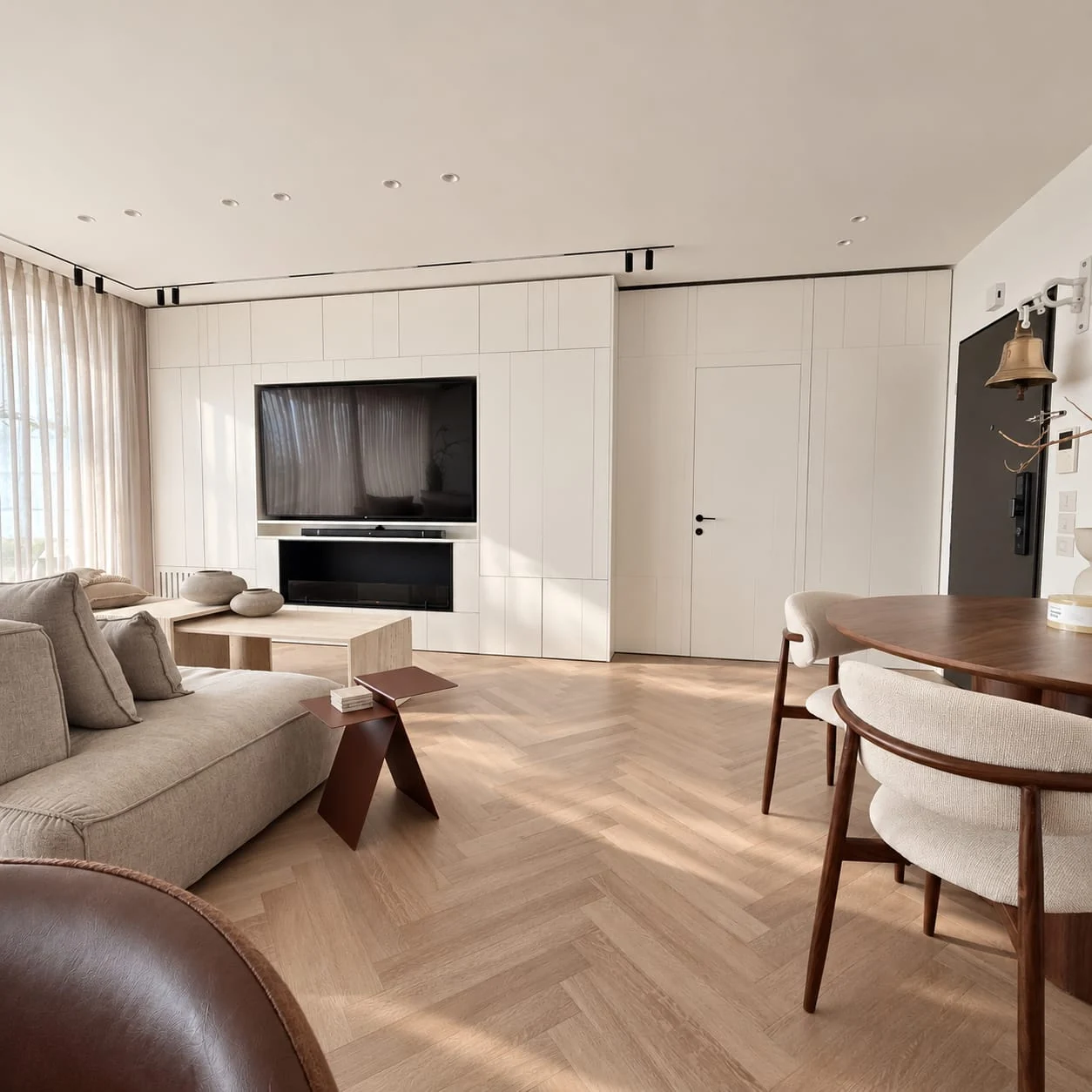 Living and dining areas sharing a herringbone-pattern floor