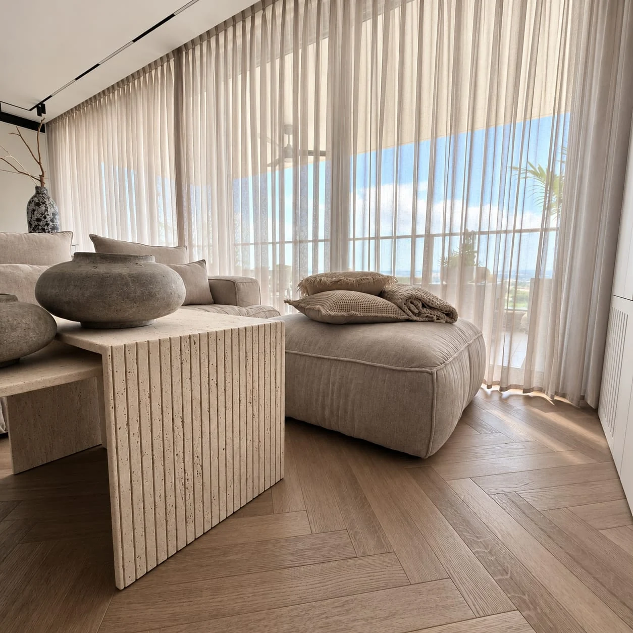 Sofa corner and living-room tables beside the corner curtains