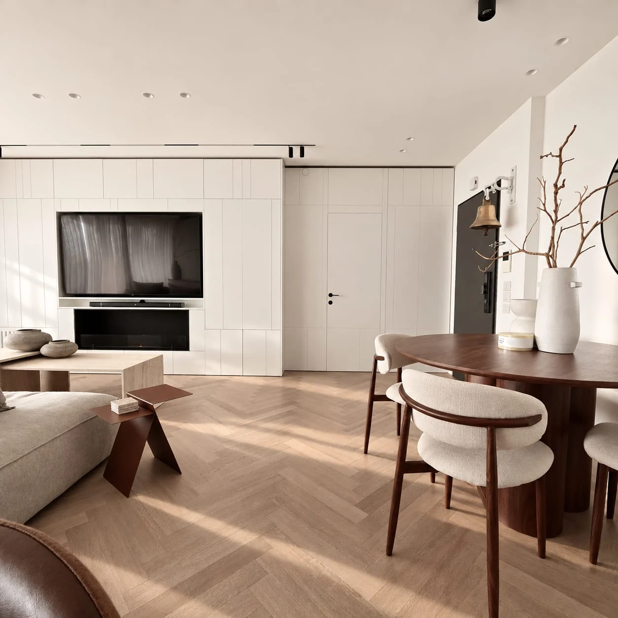 Wide view of the living and dining areas with pale storage fronts