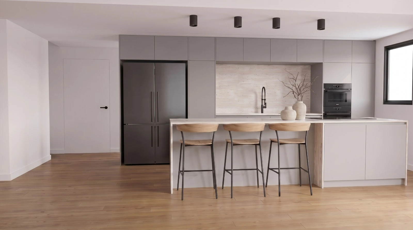 Front view of a gray kitchen with a stone island, wooden stools and oak-toned flooring.