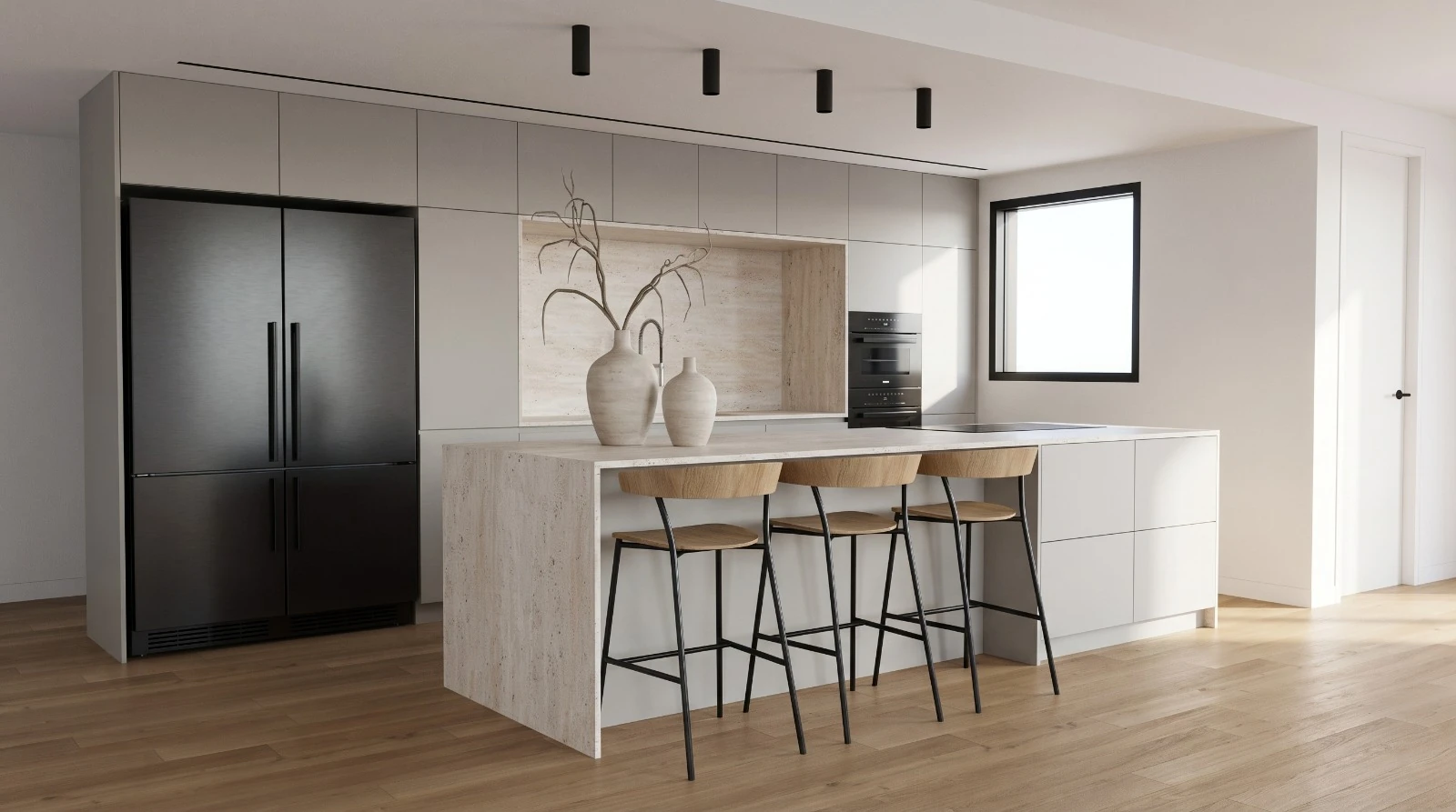 Wide view of a gray kitchen with a stone island and three wooden stools on oak-toned flooring.
